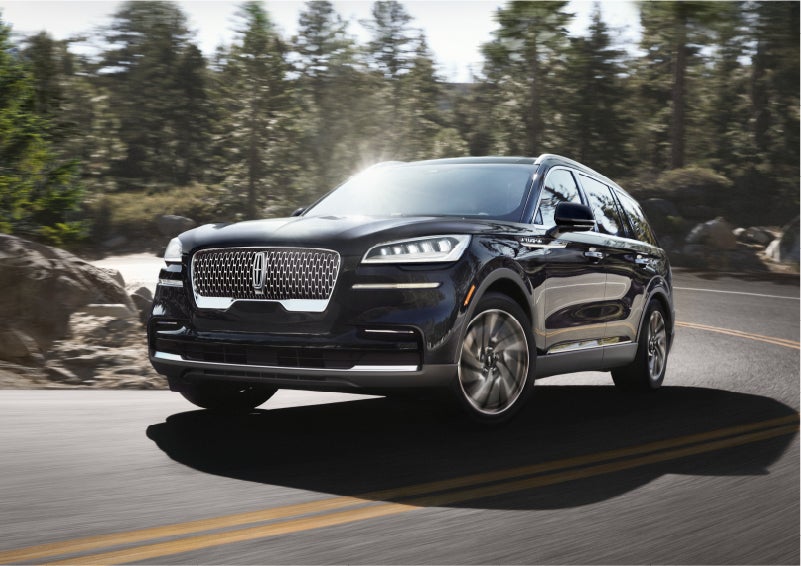 A Lincoln Aviator® SUV is being driven on a winding mountain road | White's Canyon Motors - Lincoln in Spearfish SD