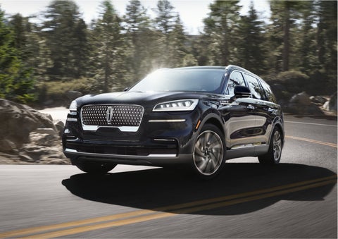 A Lincoln Aviator® SUV is being driven on a winding mountain road | White's Canyon Motors - Lincoln in Spearfish SD