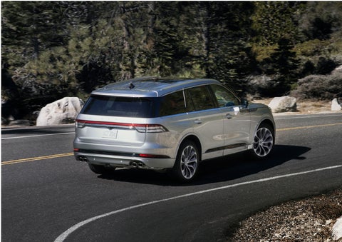 A Lincoln Aviator® is being driven on a winding road | White's Canyon Motors - Lincoln in Spearfish SD