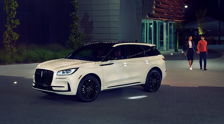 Two people approach a 2024 Lincoln Corsair® SUV featuring the available Jet Appearance Package. | White's Canyon Motors - Lincoln in Spearfish SD