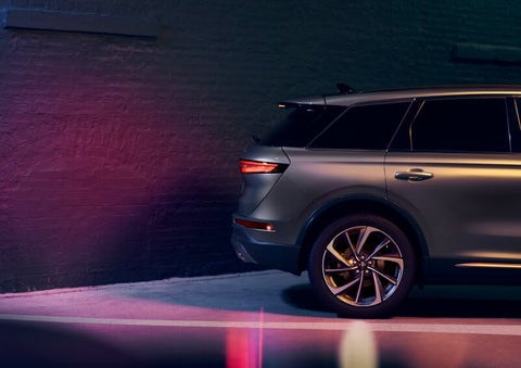 A dramatization of a 2025 Lincoln Corsair® SUV is shown backing up toward a wall. | White's Canyon Motors - Lincoln in Spearfish SD