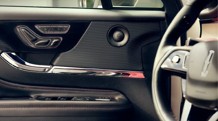 A Revel® audio speaker is shown in the driver's side door of a 2025 Lincoln Corsair® SUV. | White's Canyon Motors - Lincoln in Spearfish SD