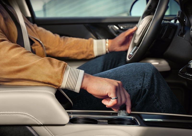 The driver of a 2024 Lincoln Corsair® SUV is shown selecting the drive mode. | White's Canyon Motors - Lincoln in Spearfish SD