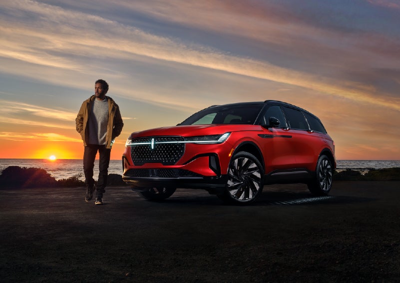 A person is shown next to a 2025 Lincoln Nautilus® SUV as the Lincoln Embrace sequence takes place. | White's Canyon Motors - Lincoln in Spearfish SD