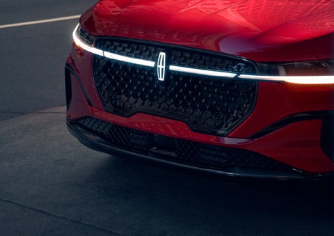 The available front LED light bar and center Lincoln Star logo glow at dusk. | White's Canyon Motors - Lincoln in Spearfish SD