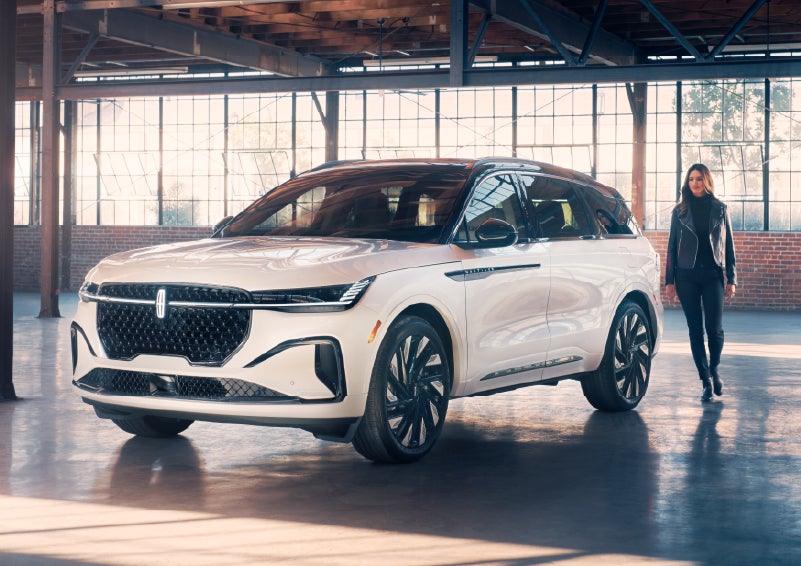 A person approaches a 2025 Lincoln Nautilus® SUV. | White's Canyon Motors - Lincoln in Spearfish SD