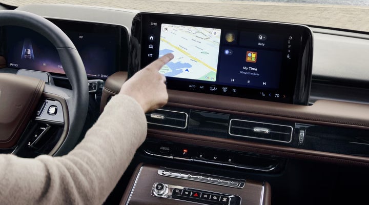 A person is tapping the center display touchscreen of a 2026 Lincoln Aviator® SUV. | White's Canyon Motors - Lincoln in Spearfish SD