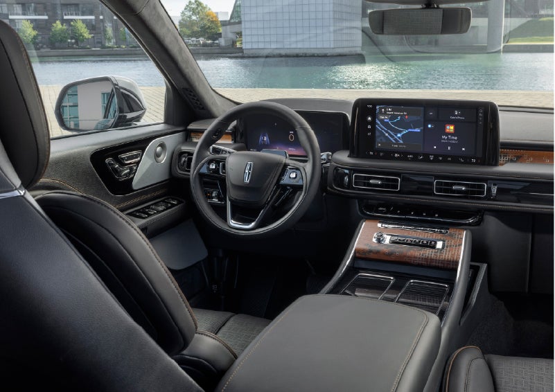 The interior of the 2026 Lincoln Aviator® SUV is shown parked with a view of a harbor through the windshield. | White's Canyon Motors - Lincoln in Spearfish SD