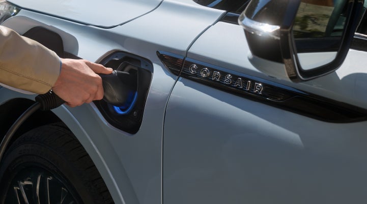 A hand is plugging in a 2026 Lincoln Corsair® Grand Touring Plug-in Hybrid SUV. | White's Canyon Motors - Lincoln in Spearfish SD