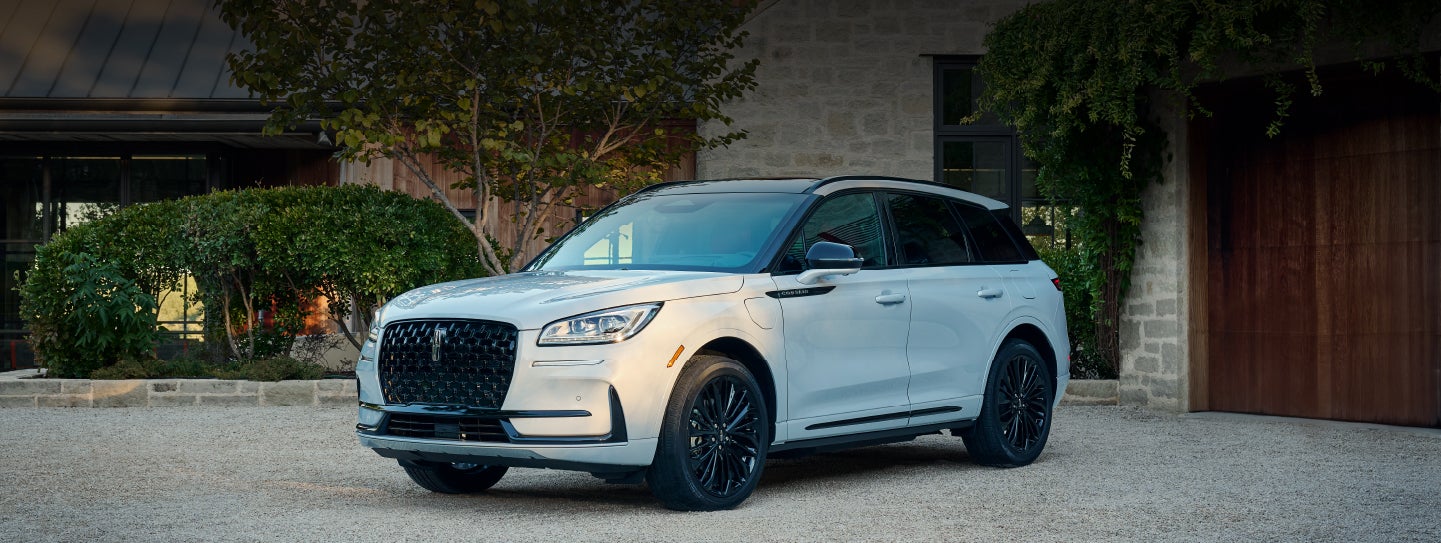 A 2026 Lincoln Corsair® SUV is parked in front off a luxury home. | White's Canyon Motors - Lincoln in Spearfish SD