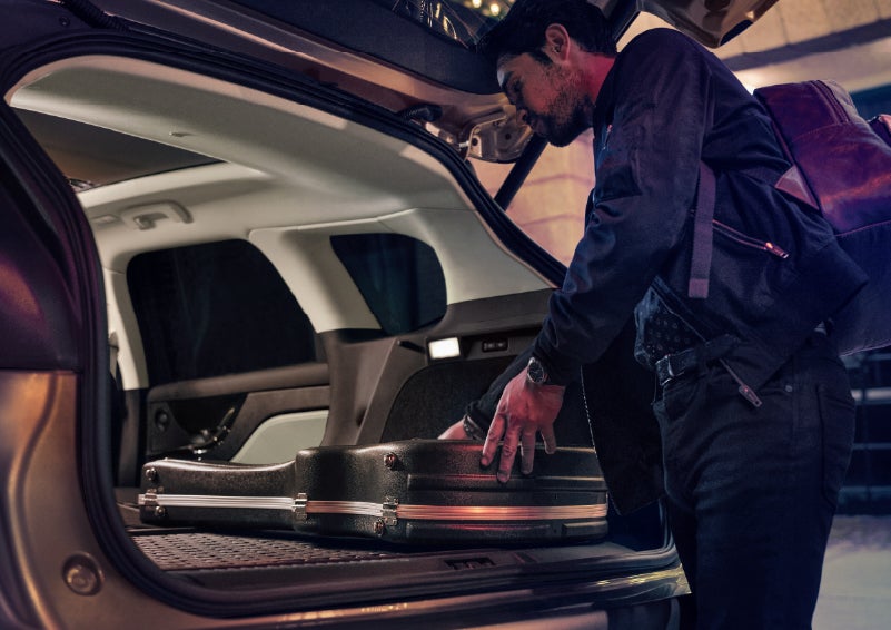 A man is shown loading cargo into the rear of a 2026 Lincoln Corsair® SUV with the second-row seats folded flat. | White's Canyon Motors - Lincoln in Spearfish SD