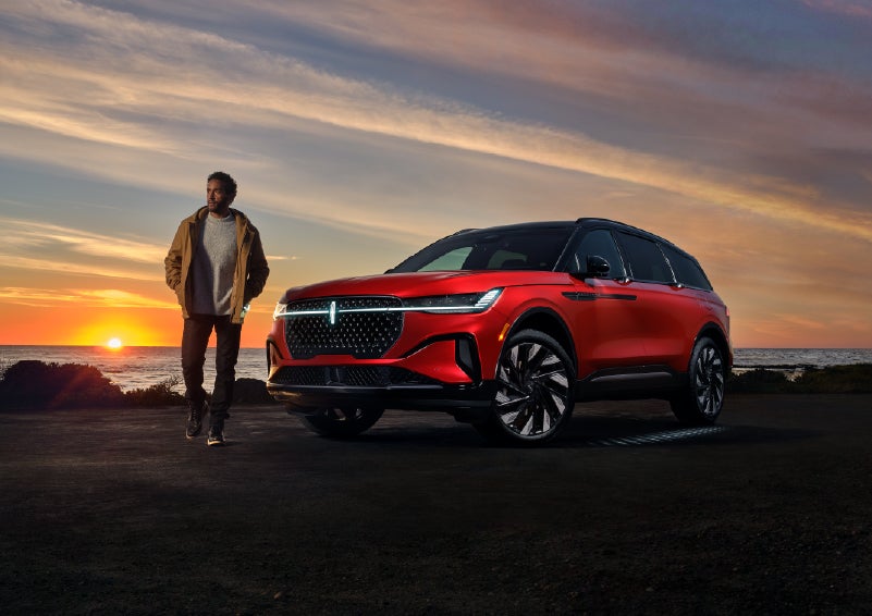 A person is shown next to a 2026 Lincoln Nautilus® SUV as the Lincoln Embrace sequence takes place. | White's Canyon Motors - Lincoln in Spearfish SD