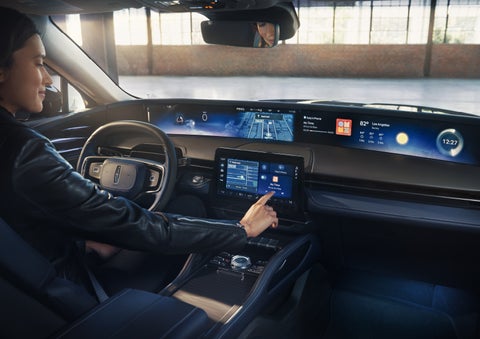 The driver of a 2026 Lincoln Nautilus® SUV interacts with the center touchscreen. | White's Canyon Motors - Lincoln in Spearfish SD