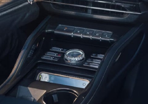 A smartphone is shown charging in the wireless charging pad. | White's Canyon Motors - Lincoln in Spearfish SD