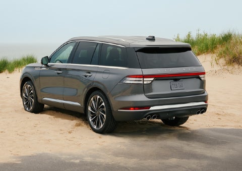 A 2027 Lincoln Aviator® SUV is parked next to sand dunes. | White's Canyon Motors - Lincoln in Spearfish SD