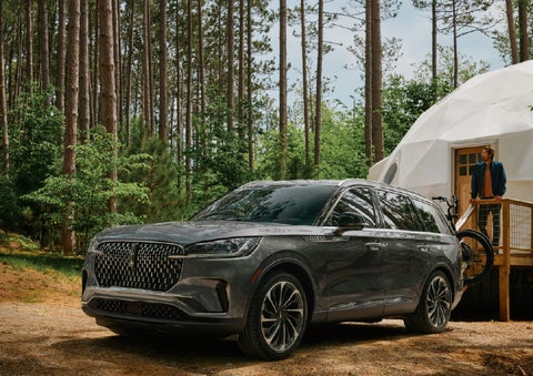 A 2027 Lincoln Aviator® is parked next to a high end glamping site. | White's Canyon Motors - Lincoln in Spearfish SD