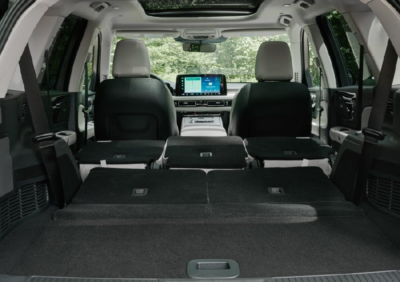 A rear to front view of the interior of a 2027 Lincoln Aviator® Black Label™ SUV shows the third and second rows folded flat | White's Canyon Motors - Lincoln in Spearfish SD
