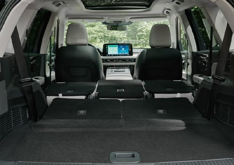 A rear to front view of the interior of a 2027 Lincoln Aviator® Black Label™ SUV shows the third and second rows folded flat | White's Canyon Motors - Lincoln in Spearfish SD