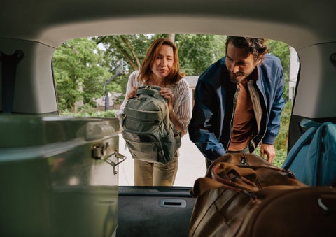 A couple loads luggage into the rear of a 2027 Lincoln Aviator® Black Label™ SUV..e 202 | White's Canyon Motors - Lincoln in Spearfish SD