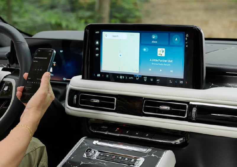 A person pairs thier phone with the center touchscreen of a 2027 Lincoln Aviator® Black Label™ SUV | White's Canyon Motors - Lincoln in Spearfish SD