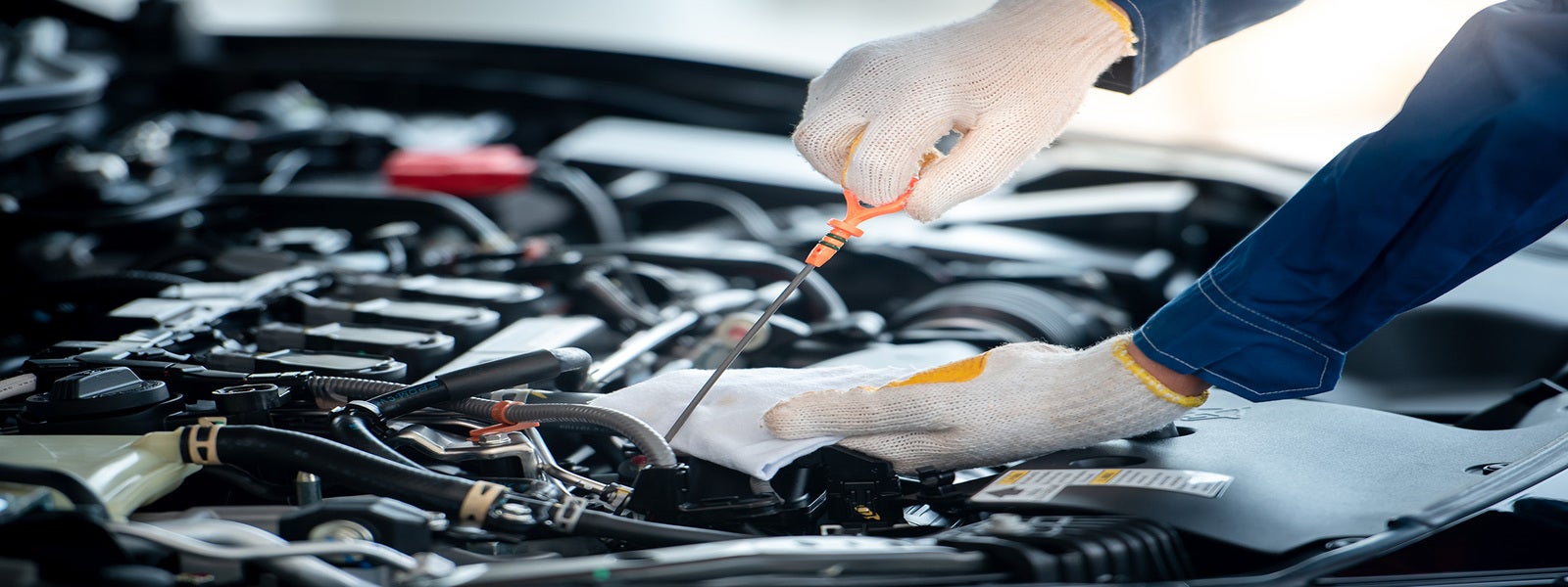 Technicians reviewing information beside a vehicle.