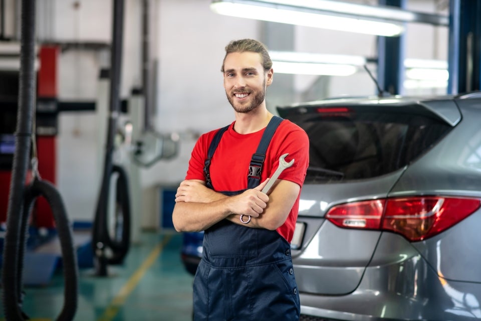 Auto technician standing in repair workshop