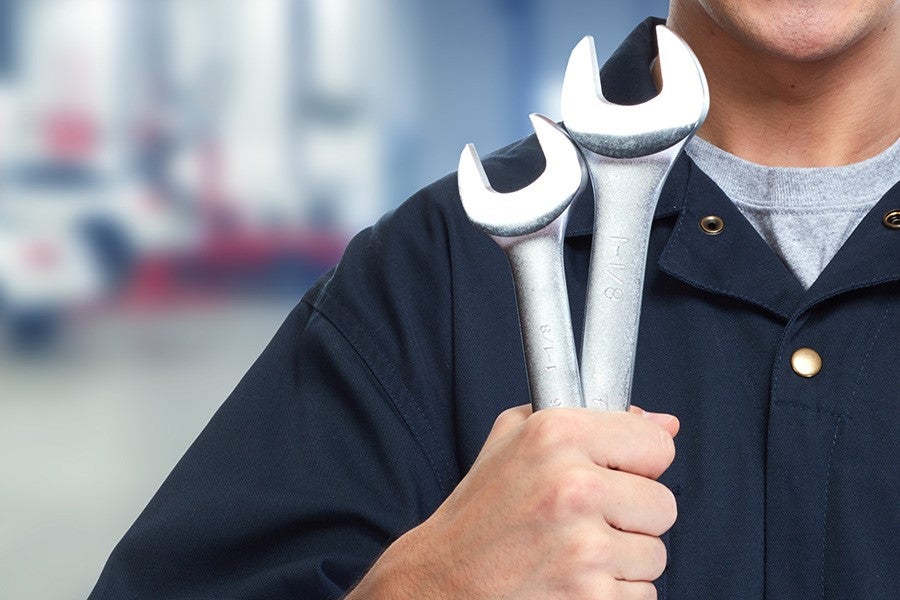 Mechanic holding repair tools
